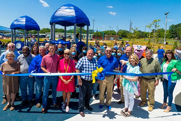 large group at ribbon cutting at Kids Town
