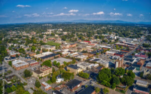 Aerial view of downtown Cleveland, Tennessee in summer, showcasing the layout of buildings, streets, and surrounding greenery — part of Bliss Products and Services' regional visual documentation.