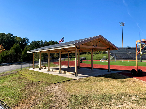 Covered pedestrian bridge by Bliss Products and Services blending into wooded surroundings at Chesapeake City Hall, Virginia