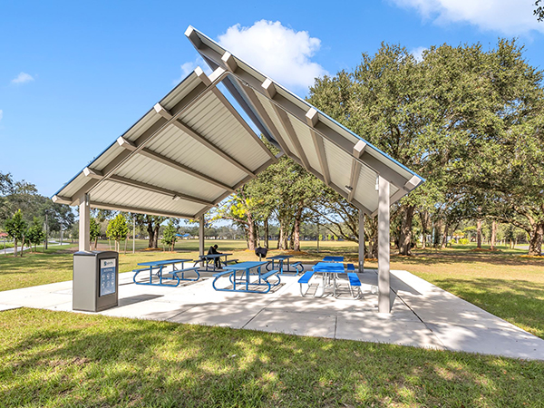 Metal shade structure with picnic tables at Rolling Oaks Park in Miami Gardens, Florida, part of the City’s GO Bond park improvement project.