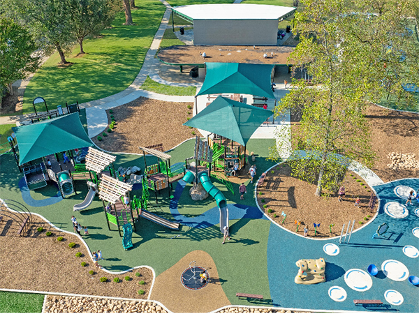 Riverview Park — Inclusive Community Playground, Chattanooga, TN | Bliss Products and Services Aerial view of Riverview Park inclusive community playground in Chattanooga, TN with inclusive play and adaptive play equipment, shade structures, and nature play surfacing — Bliss Products and Services.