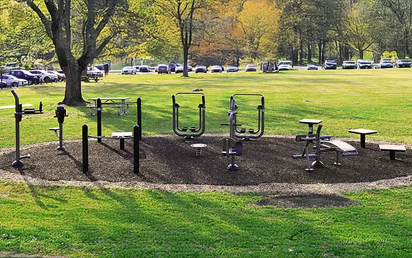 Outdoor fitness circuit with multiple ActionFit stations on wood-fiber surfacing