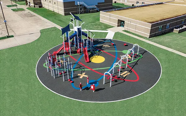 Overhead view of a circular playground with custom surfacing graphics, available from Bliss