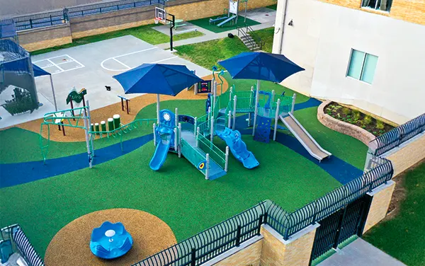 Arial view of a courtyard playground with safety surfacing and shade in McDonald Chapel, Jefferson Alabama available from Bliss Products and Services.
