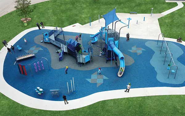 Overhead view of a ramped play system with towers and a large slide, available from Bliss Products and Services.