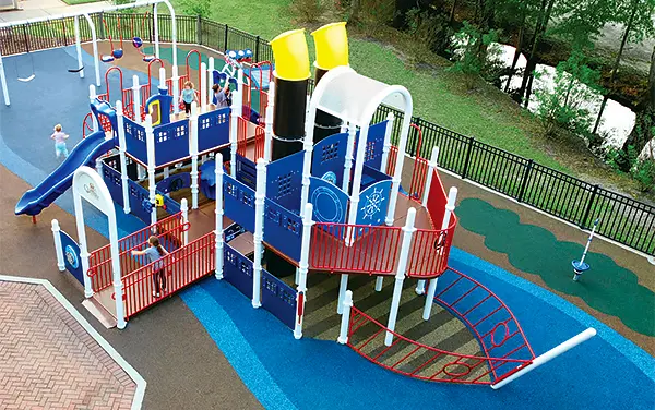 Overhead view of a large ship-themed playground with ramps on poured-in-place surfacing, available from Bliss Products and Services.