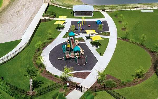 Overhead view of a neighborhood park with a playground, shade sails, and loop paths in Colbert County, Alabama, available from Bliss Products and Services.