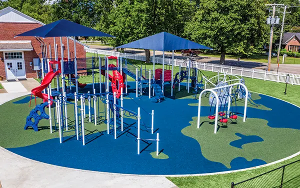 Elevated view of a school playground with shade canopies on poured-in-place surfacing, available from Bliss Products and Services, used for Bell, FL recreation planning.