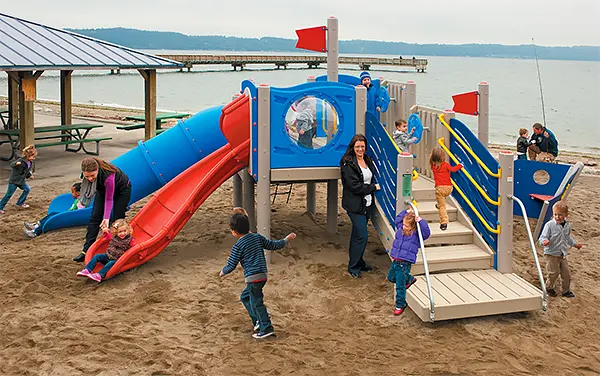 Beachfront Playground with Slides and Pavilion Beachfront playground with slides next to a pavilion, available from Bliss Products and Services.