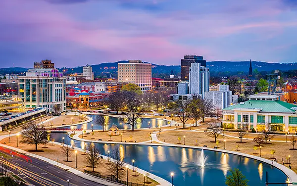 Huntsville skyline and Big Spring Park at dusk in Alabama with fountains and waterfront paths, used by Bliss Products and Services