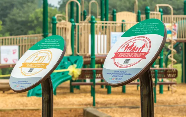 Inclusive playground signage highlighting the 7 Principles of Inclusive Playground Design and National Demonstration Site, available from Bliss Products and Services.