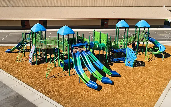 Large School Playground with Multiple Slides Large school playground on engineered wood fiber with multiple slides, available from Bliss Products and Services.