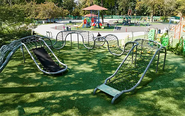 Contoured net climbers on a playground slope, available from Bliss Products and Services.
