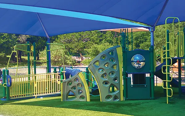 Rectangle hip shade covering a playground with slides and climbers