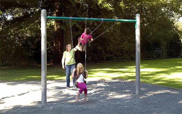 Family using a single-bay playground swing frame in Chilton, Alabama