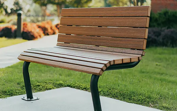 Contoured slat bench with curved seat in a landscaped greenspace in Active, Bibb County, Alabama
