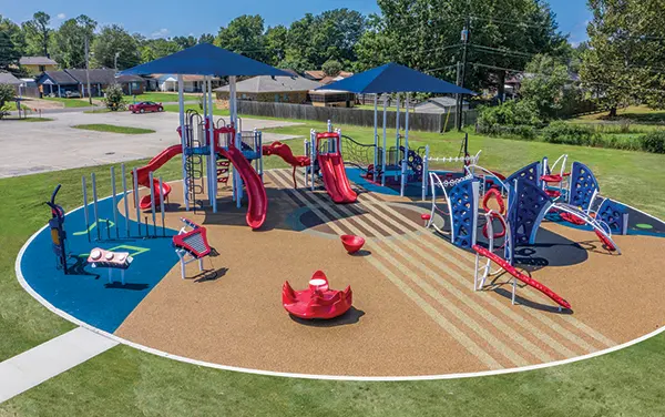 Aerial Circular Playground with Custom Surfacing Graphics Overhead view of a circular playground with custom graphics on unitary surfacing, available from Bliss Products and Services.