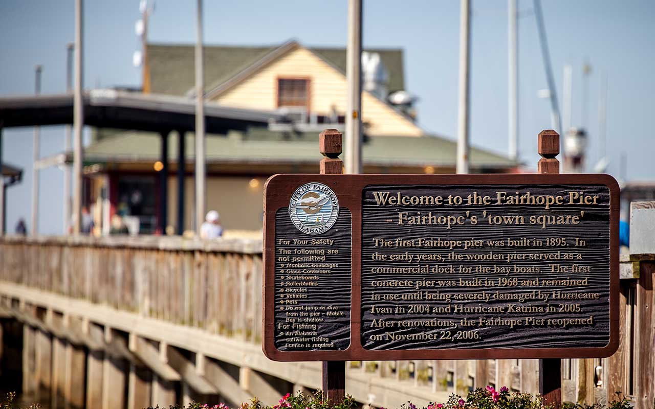 Welcome sign at Fairhope Municipal Pier with the City of Fairhope seal and pier in the background, available from Bliss Products and Services.