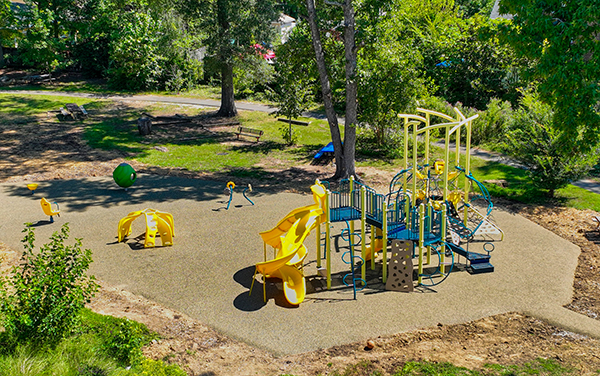 George-Watts-2 Aerial view of large elevated aluminum grandstand next to a blue running track.