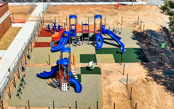 Glen1 Aerial view of large elevated aluminum grandstand next to a blue running track.