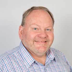 Will-McNeer-vcf Toddlers and young children playing on an early childhood playground with poured rubber surfacing under a large rectangular green shade canopy at Memorial Hospital Children’s Learning Center in Chattanooga Tennessee, supplied by Bliss Products and Services.