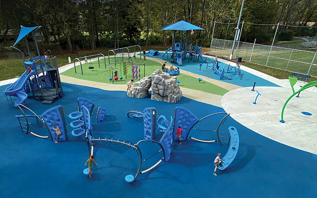 Kids playing on a perforated deck inside a pyramid rope structure, available from Bliss Products and Services.