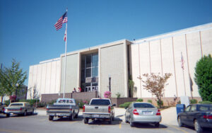 Chilton County Courthouse in Clanton, Alabama with modern facade and flagpoles, Bliss Products and Services