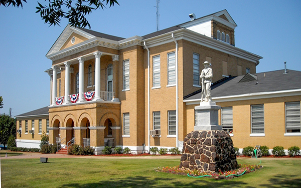Choctaw County Courthouse in Butler, Alabama with columned portico and soldier statue, Bliss Products and Services
