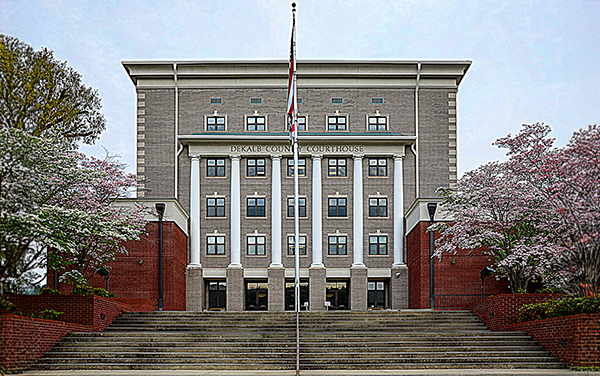 DeKalb County Courthouse in Fort Payne, Alabama, with columns and spring dogwoods. Used by Bliss Products and Services.