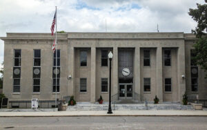 Franklin County Courthouse in Russellville, Alabama, with columns and a central clock. Used by Bliss Products and Services.
