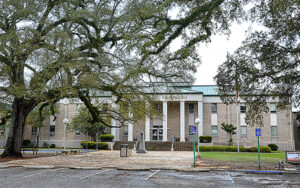Geneva County Courthouse in Geneva, Alabama, with columned facade and live oaks. Used by Bliss Products and Services.
