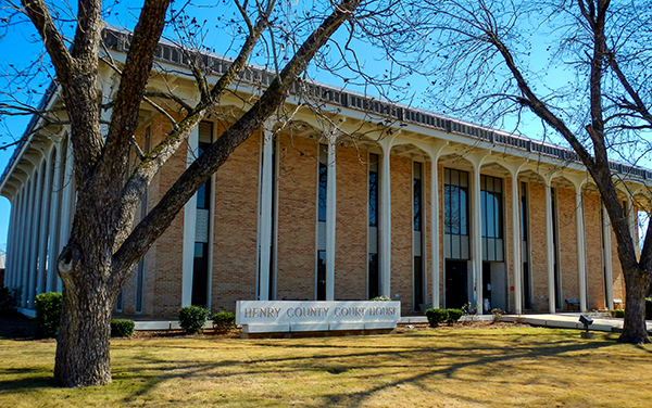 Henry County Courthouse in Abbeville, Alabama, brick facade with tall columns. Used by Bliss Products and Services.