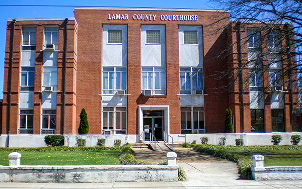 Lamar County Courthouse in Vernon, Alabama, red-brick facade with landscaped lawn. Used by Bliss Products and Services.