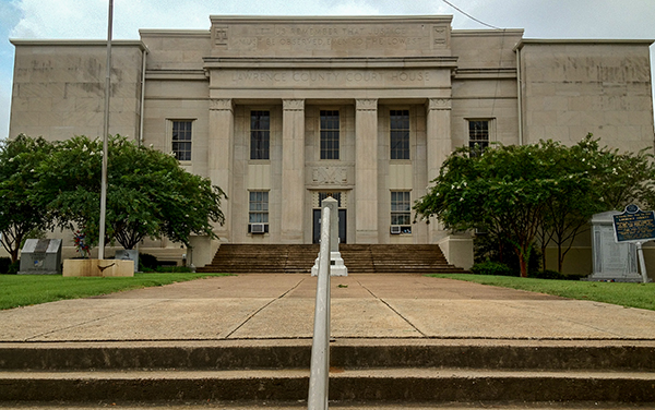 Lawrence County Courthouse in Moulton, Alabama, stone facade with columns and central steps. Used by Bliss Products and Services.