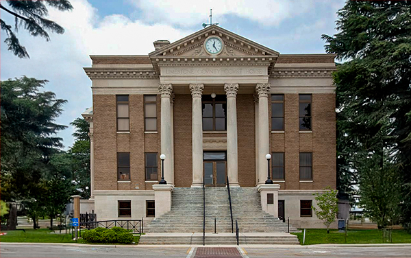 Limestone County Courthouse in Athens, Alabama, neoclassical facade with columned portico and clock. Used by Bliss Products and Services.