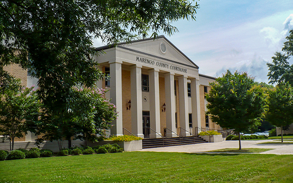 Marengo County Courthouse in Linden, Alabama, with a columned portico and landscaped grounds. Used by Bliss Products and Services.