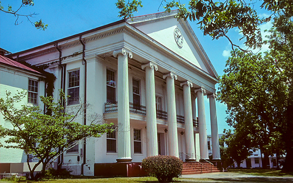 Perry County Courthouse in Marion, Alabama, Greek Revival facade with six columns and a pediment clock.