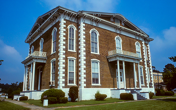 Pickens County Courthouse in Carrollton, Alabama—Italianate brick facade with arched windows and small balconies.