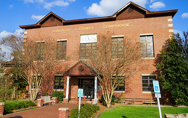 Randolph County Courthouse in Wedowee, Alabama, red-brick civic building with central clock panel and front portico.