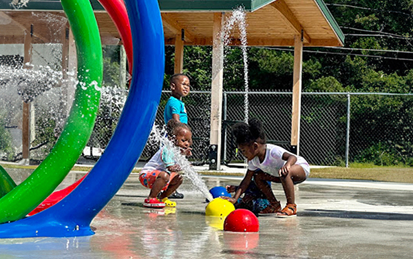 splashpad Blue expanded-metal picnic table with black frame on a concrete patio.