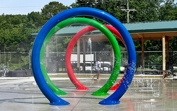 splashpads Ballfield dugout bench shelter with chain-link fence, available from Bliss Products and Services.