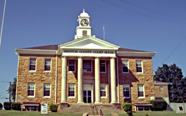 Winston County Courthouse, Double Springs, Alabama, with clock tower and white columns, for Bliss Products and Services.