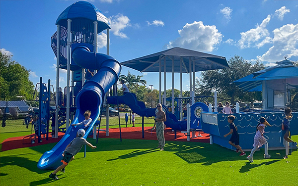 Fleischmann-Park-hero Aerial view of large elevated aluminum grandstand next to a blue running track.