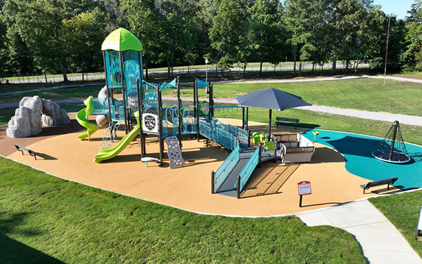 Rectangle hip shade with four posts covering a small playground