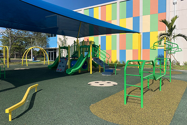 Shaded playground with poured in place rubber surfacing at Bunche Park Elementary in Miami Gardens, Florida, installed by Patty Carruthers with Bliss Products and Services.