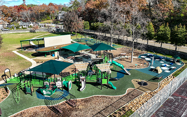 Aerial view of the inclusive Riverview Park playground in Chattanooga, Tennessee with shaded play structures and safety surfacing by Bliss Products and Services.