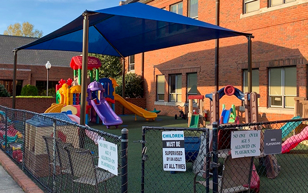 Player reaches under the basket for a reverse layup