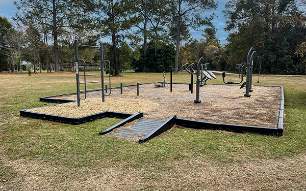 Fort Braden Florida Adult Outdoor Fitness Station Adult outdoor fitness station at Fort Braden Florida with strength equipment, safety surfacing, and an accessible ramp provided by Bliss Products and Services