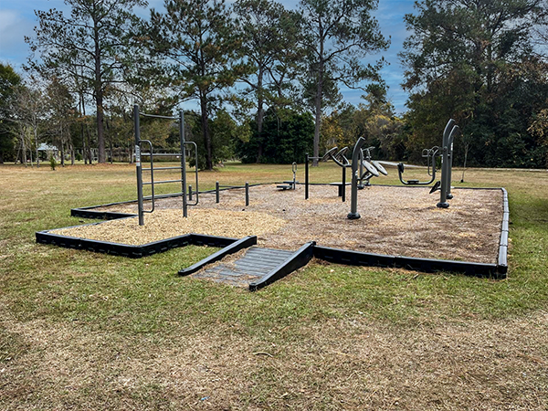 Fort Braden Florida Adult Outdoor Fitness Station Adult outdoor fitness station at Fort Braden Florida with strength equipment, safety surfacing, and an accessible ramp provided by Bliss Products and Services