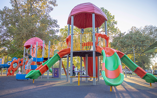 Aerial view of large elevated aluminum grandstand next to a blue running track.